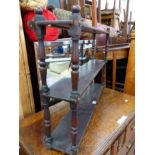 A MAHOGANY THREE TIER WALL SHELF.