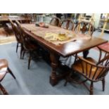 A BESPOKE OAK REFECTORY TYPE DINING TABLE WITH CLEATED PLANK TOP AND "H" BASE STRETCHER.