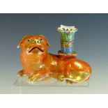 A 19th C. CHINESE RECLINING PUG DOG CANDLESTICK, THE ORANGE DOG WITH GILT DETAILS, THE NOZZLE ON ITS