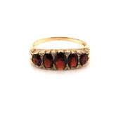A VINTAGE GARNET AND DIAMOND GRADUATED CARVED HALF HOOP RING. DATED 1979, LONDON. FINGER SIZE Y.
