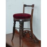 A VICTORIAN ROSEWOOD ADJUSTABLE HEIGHT PIANO STOOL WITH SHORT RAISED BACK.