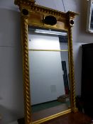 A REGENCY AND LATER RECTANGULAR MIRROR IN A GILT FRAME, THE BEADED CORNICE OVER A CENTRAL BLACK SHEL