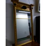 A REGENCY AND LATER RECTANGULAR MIRROR IN A GILT FRAME, THE BEADED CORNICE OVER A CENTRAL BLACK SHEL