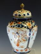 AN 18th C. JAPANESE IMARI JAR AND COVER, THE SHOULDERS AND LID WITH CHRYSANTHEMUMS IN LIGHT