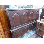 A GEORGE III AND LATER ADAPTED OAK CABINET WITH TWO DOORS OVER THREE DRAWERS. H 109 X W 144 X D