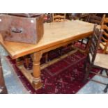 A PINE REFECTORY TABLE, THE CLEATED PLANK TOP ON BALUSTER LEGS WITH SQUARE FEET. W 217 x D 83 x H