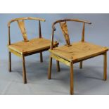 A PAIR OF MID CENTURY BLACK FIGURED HARDWOOD CHAIRS WITH CURVED CYLINDRICAL TOP RAILS, THE U-TOPPE