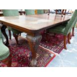 A LATE VICTORIAN MAHOGANY RECTANGULAR DINING TABLE ON FOUR CABRIOLE LEGS WITH BALL AND CLAW FEET AND