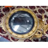 A 19th CENTURY CONVEX WALL MIRROR WITH EAGLE SURMOUNT