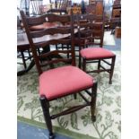 A SET OF EIGHT BESPOKE LANCASHIRE LADDER BACK SIDE CHAIRS WITH UPHOLSTERED SEAT PADS.