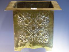 AN ARTS AND CRAFTS BRASS PLANTER, THE FLAT RIM OVER BOSSES ON TWO OF THE SQUARE SIDES AND A FLOWER