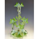 A LATE VICTORIAN GREEN VASELINE GLASS EPERGNE, THE CENTRAL PETAL TOPPED TRUMPET VASE FLANKED BY