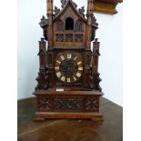 A VICTORIAN GOTHIC REVIVAL CASED CUCKOO CLOCK.