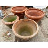 A PAIR OF LARGE TERRACOTTA PLANTERS AND TWO OTHERS ALL WITH SWAG DECORATION