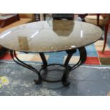 A MARBLE TOPPED ART DECO STYLE CENTRE IRON TABLE SUPPORTED ON FOUR SCROLL LEGS JOINED ABOVE THE FEET