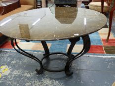 A MARBLE TOPPED ART DECO STYLE CENTRE IRON TABLE SUPPORTED ON FOUR SCROLL LEGS JOINED ABOVE THE FEET