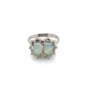 AN 18ct HALLMARKED WHITE GOLD OPAL AND DIAMOND DOUBLE CLUSTER RING, THE TWO OVAL OPALS IN CLAW