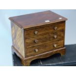 A 20th C. MAHOGANY MINIATURE CHEST OF THREE DRAWERS ON BRACKET FEET. W 41 x D 28 x H 33cms.