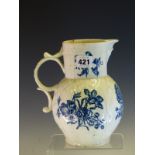 AN 18th C. WORCESTER BLUE AND WHITE MASK JUG PRINTED WITH ROSES AND OTHER FLOWER IN SPRAYS, CRESCENT