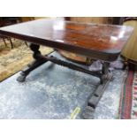A VICTORIAN ROSEWOOD TABLE, THE ROUNDED RECTANGULAR TOP ON BALUSTER PILASTERS AT EACH NARROW END,