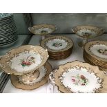 A VICTORIAN DESSERT SERVICE, EACH PIECE PAINTED WITH A BUNCH OF FLOWERS WITHIN GILDING ON A BEIGE