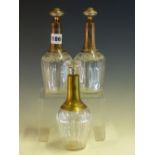 A PAIR OF FRENCH FLORAL ENGRAVED CLEAR GLASS BOTTLES AND STOPPERS WITH SILVER MOUNTED NECKS,