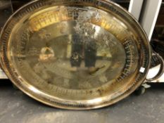 AN ELECTROPLATE TWO HANDLED OVAL TRAY WITH THE DATE 1880 BELOW THE CENTRAL CREST AND MOTTO