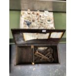 A WOODEN TOOL BOX WITH VINTAGE SPANNERS AND A QUANTITY OF GOSS WARE