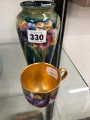 A MOORCROFT IRIS PATTERN VASE TOGETHER WITH A WORCESTER COFFEE CUP PAINTED WITH FRUIT BY W H AUSTIN