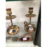 A PAIR OF DOULTON STONE WARE CANDLESTICKS WITH RING HANDLED BASES TOGETHER WITH A RED GLASS DOUBLE