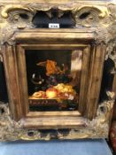A PAIR OF STILL LIVES OF FRUIT, OIL ON PANEL AND IN GILT AND BLACK ELABORATE FRAMES. 55 x 47cms.