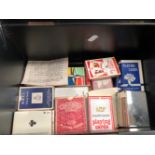 A TIN BOX OF PLAYING AND TRICK CARDS