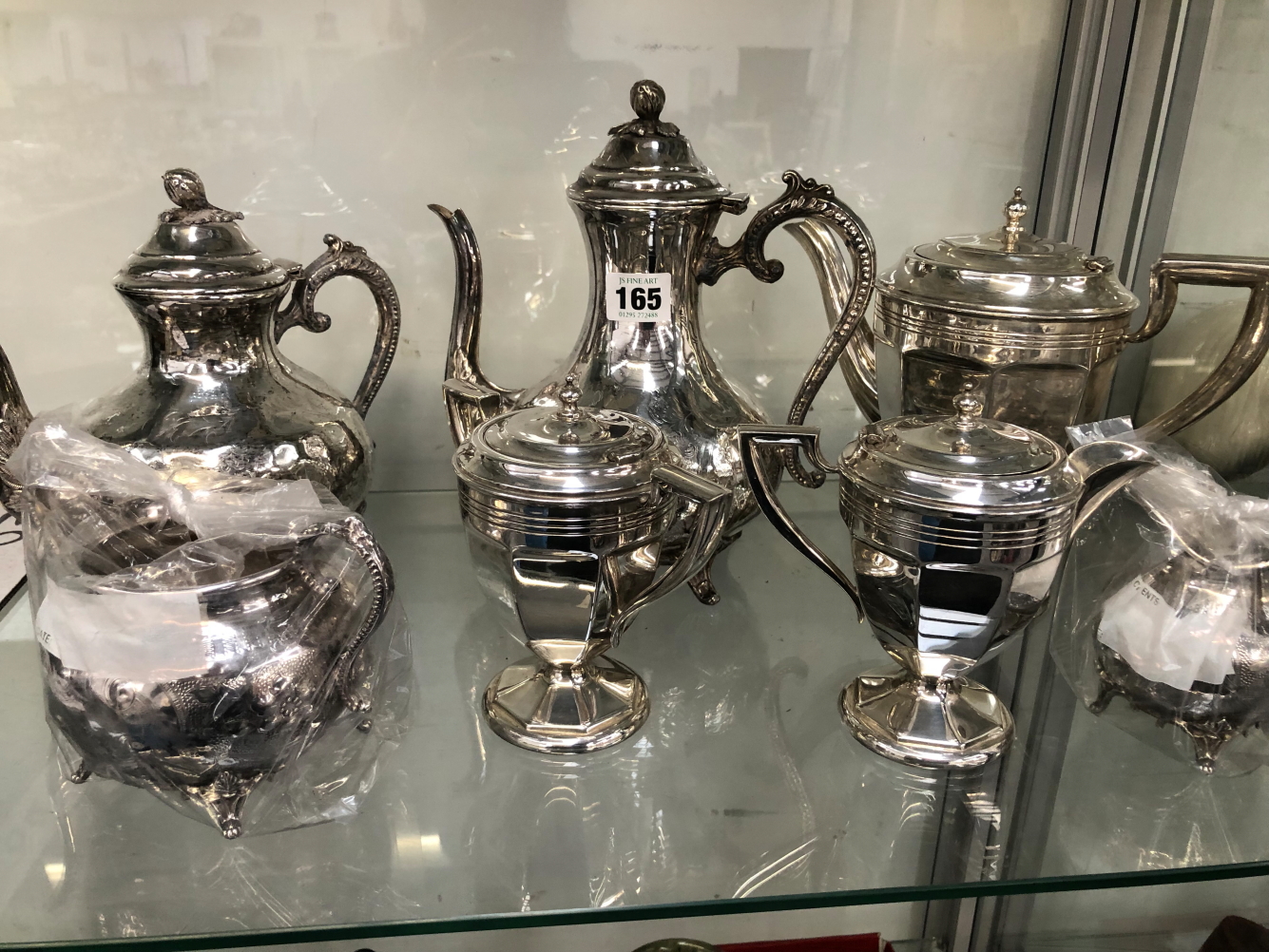 AN ELECTROPLATE FOUR PIECE TEA SET TOGETHER WITH A THREE PIECE SET