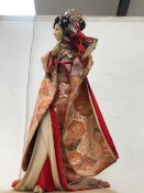A JAPANESE FIGURE OF A LADY PLAYING A DRUM