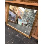 A DECORATIVE GILT FRAMED MIRROR