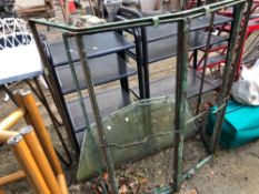 A VINTAGE IRON BAY WINDOW FRAME WITH TOP AND BOTTOM GLASS PANELS