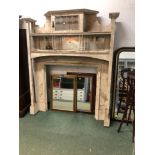 AN ART NOUVEAU PAINTED MIRROR BACK MANTLE PIECE, LEADED GLAZED DOOR ABOVE SHELVES. W 160 x 193cms