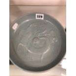 A CHINESE LAVENDER GLAZED DISH MOULDED IN RELIEF WITH A DRAGON
