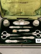 AN ANTIQUE SILVER MOUNTED CASED MANICURE SET.