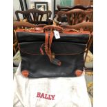 A BALLY BLACK LEATHER CASE TO TAKE CLOTHES ON HANGERS AND CENTRALLY FOLD FOR CARRYING