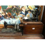 A MAHOGANY CASED WILLCOX AND BRIGGS SEWING MACHINE TOGETHER WITH ANOTHER SEWING MACHINE