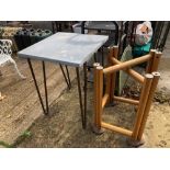AN INDUSTRIAL STYLE TABLE TOGETHER WITH ANOTHER MODERN TABLE BASE