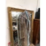 A RECTANGULAR BEVELLED GLASS MIRROR IN A GILT FRAME. 167 x 105cms.