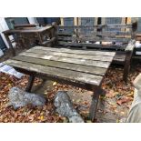 A LARGE TEAK GARDEN BENCH TOGETHER WITH A SIMILAR TABLE