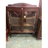 A VINTAGE MAHOGANY BOWFRONT DISPLAY CASE