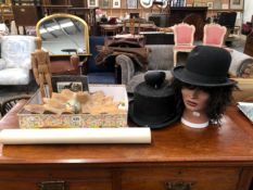 A TOP HAT, A BOWLER HAT, AN ARTISTS MANNEQUIN, A ROLL OF 1970S WALL PAPER, A CARVED WOOD SHELL,