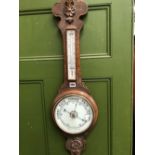 AN OAK BANJO CASED ANEROID BAROMETER WITH A MERCURY THERMOMETER