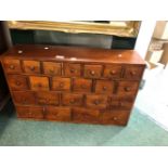 A HARDWOOD TWENTY TWO DRAWER SPICE CABINET. H 58 W 91cms