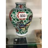 A CHINESE FAMILLE VERTE VASE PAINTED WITH TWO LIONS AMONGST RED FLOWERS AND GREEN FOLIAGE