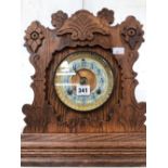 AN OAK CASED ANSONIA MANTEL CLOCK STRIKING ON A COILED ROD